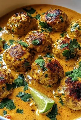 Juicy Thai-Style Chicken Meatballs in Silky Coconut Curry Sauce with Herbs and Lime